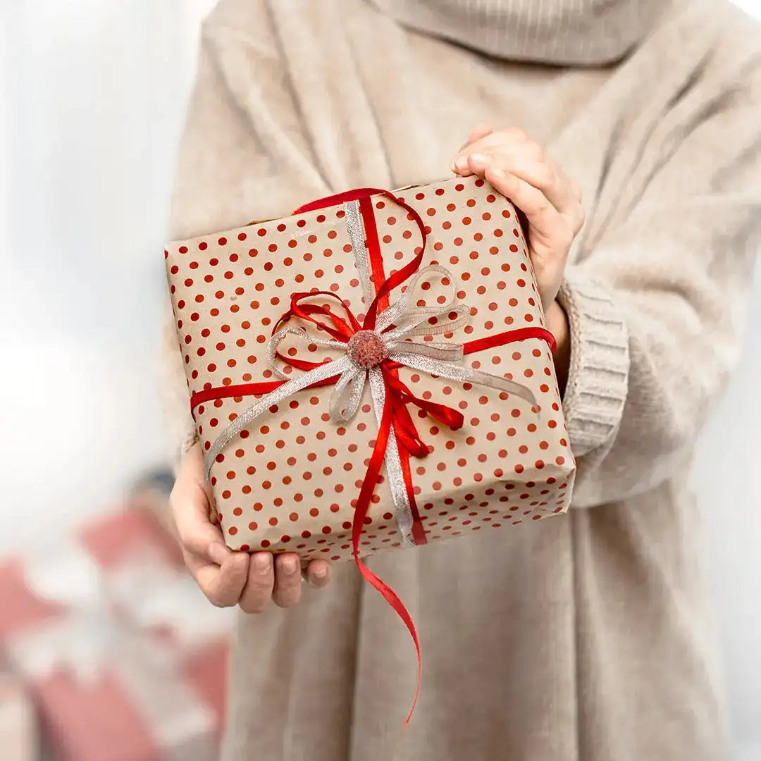 Gift wrapped in polka dot paper with a red ribbon bow for an unforgettable Eid celebration