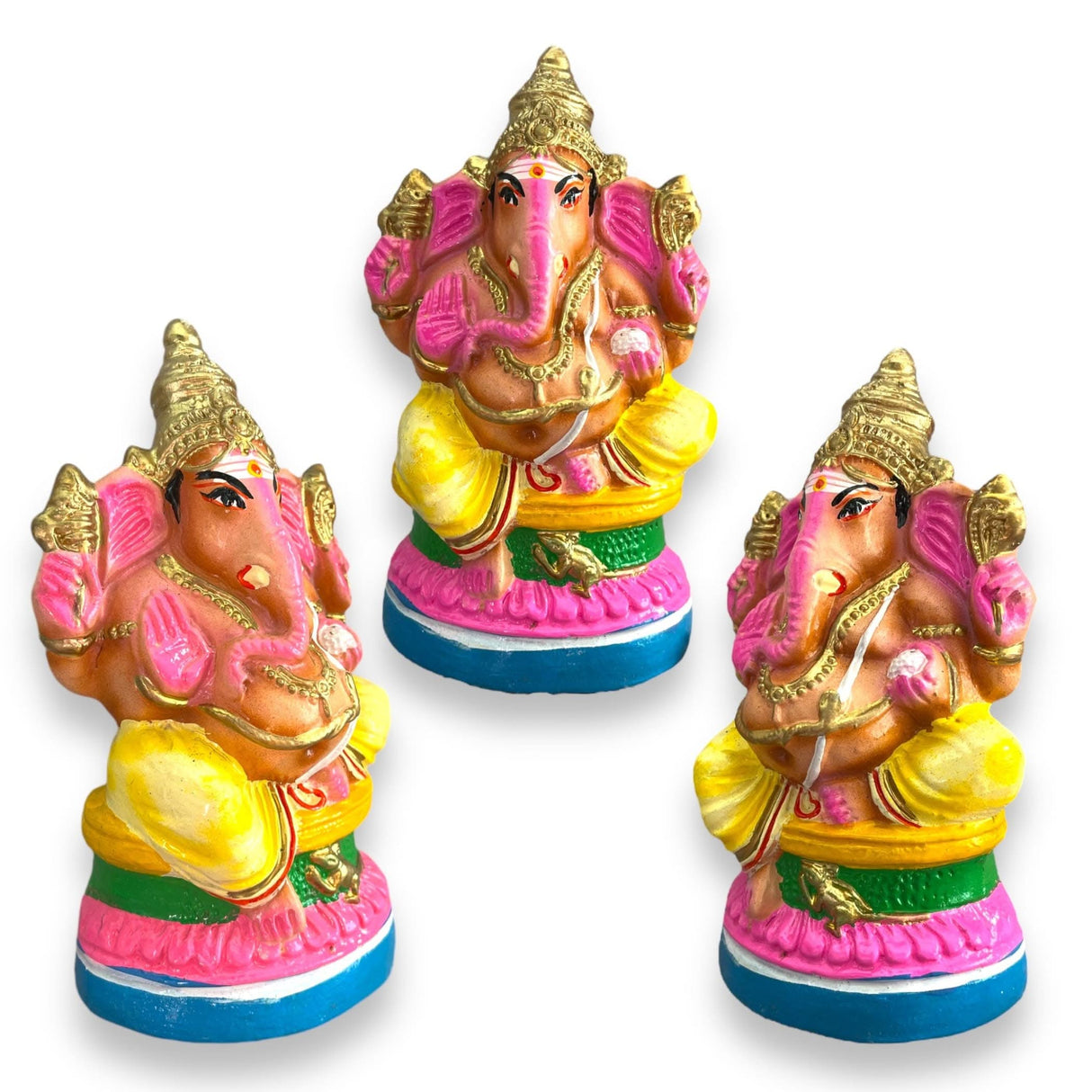 Three colorful Ganesha statues used as Hindu deity idols for home decor and spiritual worship