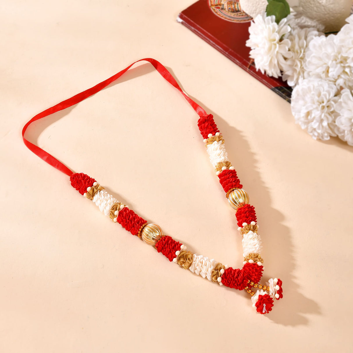 Red white floral rakhi with gold accents on 12 inch idol mala garland
