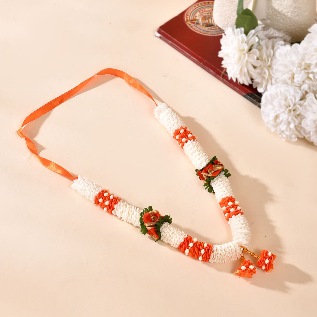 Delicate white orange floral idol mala garland with satin ribbon strap