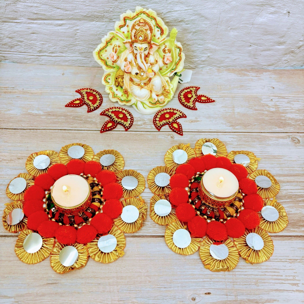 Festive candle holders with Ganesh idol and decorative accents for Diwali and holiday decor