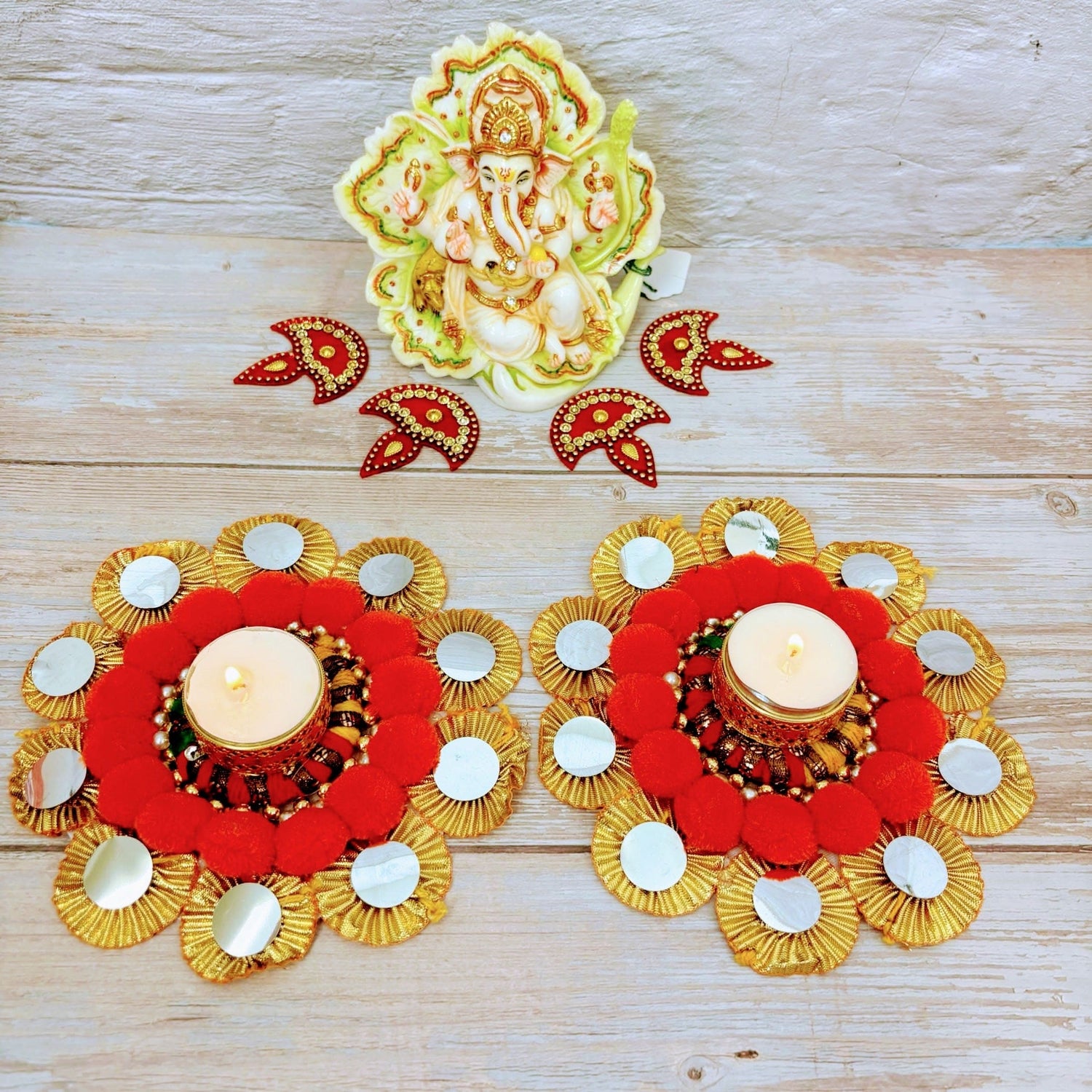 Festive candle holders with Ganesh idol and decorative accents for Diwali and holiday decor
