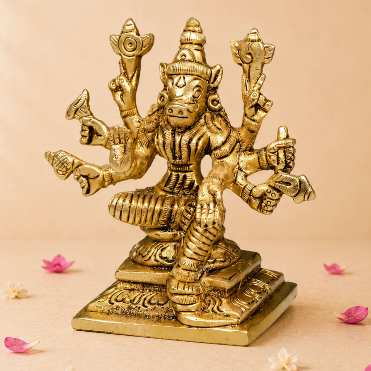 Golden brass statue of hindu goddess varahi with multiple arms and pig-like face seated on ornate base for pooja room