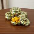 Golden floral tin with lid and decorative design for sweet and spice storage