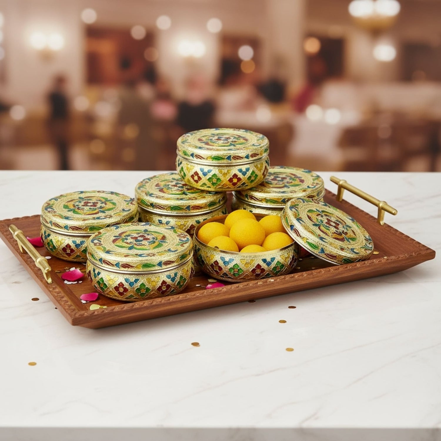 Green and gold floral decorative tins on a wooden tray for sweet and spice storage