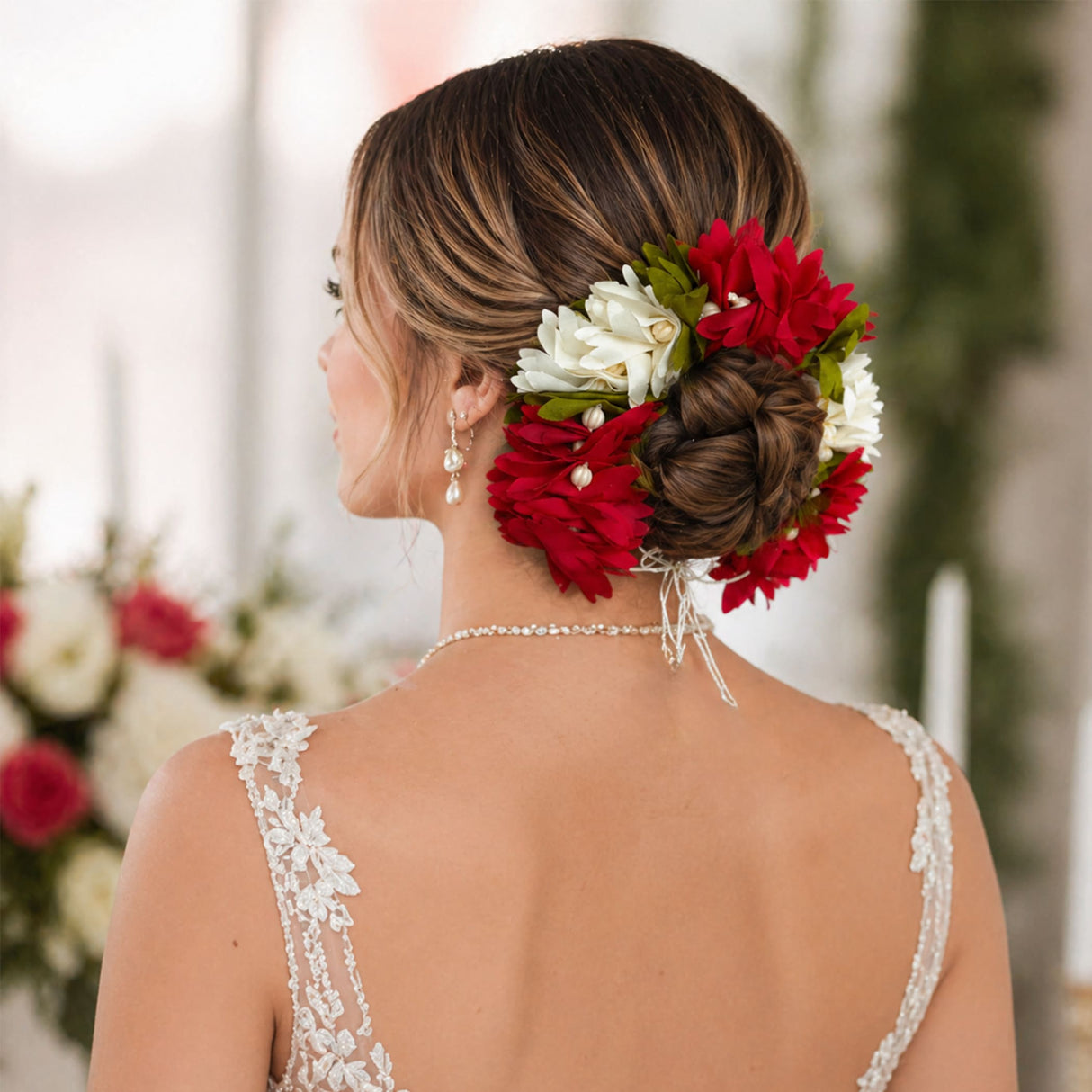 A vibrant red and white floral fabric artificial gajra adorning a styled updo for traditional bridal wear