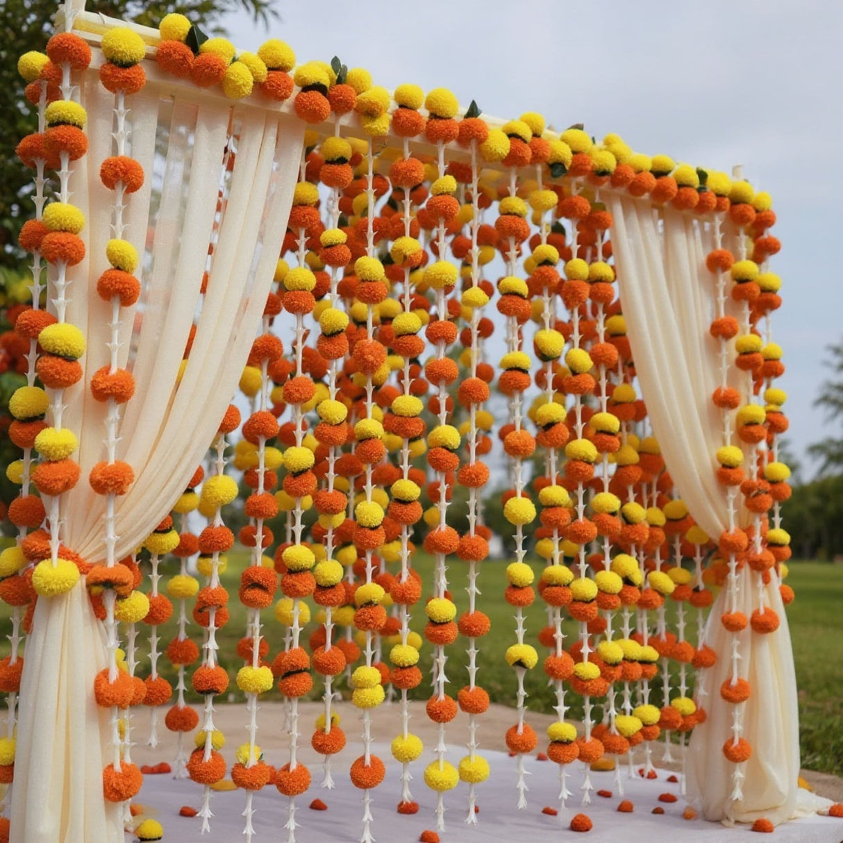 Decorative archway with yellow and orange marigold flower strands for festive celebrations
