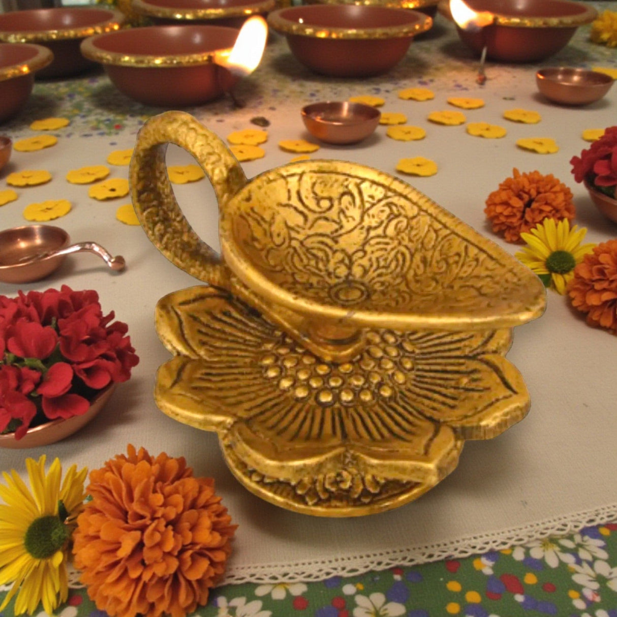 Golden intricately engraved lotus brass diya with handle for Diwali pooja