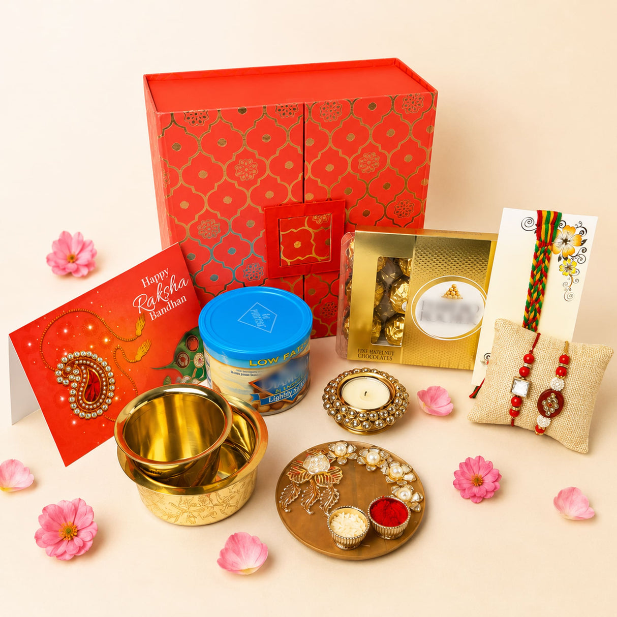 Raksha bandhan gift hamper set with red and gold patterned gift box for brother and bhabhi containing traditional rakhis and accessories