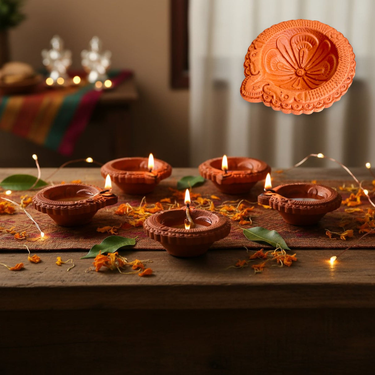 Traditional handmade terracotta diya set with lit wicks on wood