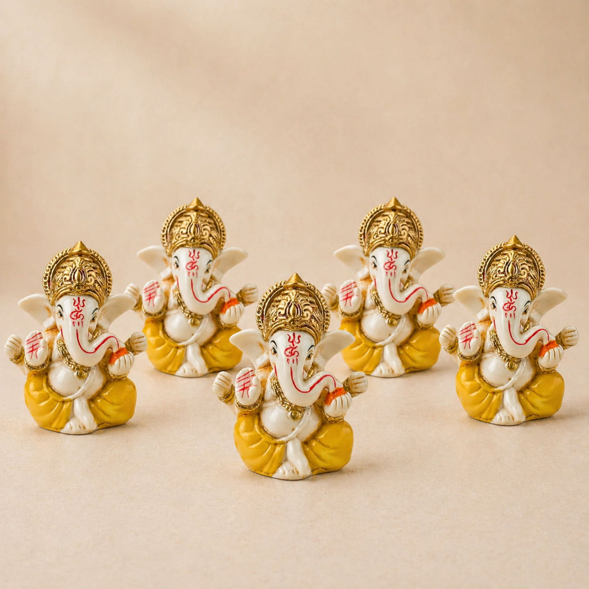 Set of five white and gold acrylic ganesha idols with red markings seated for home temple and festive decor