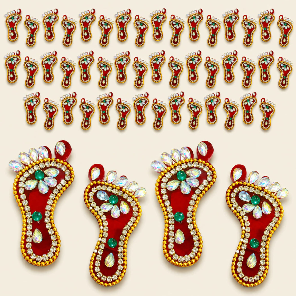 Acrylic lakshmi charan paduka feet in red and gold adorned with green and clear rhinestones for diwali decor
