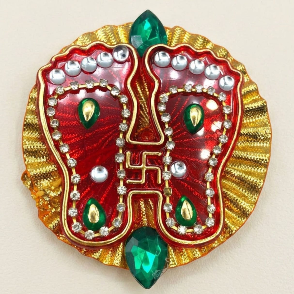 Acrylic Lakshmi Charan Paduka feet decorative pin in red and gold with silver rhinestones green gems and swastika symbol