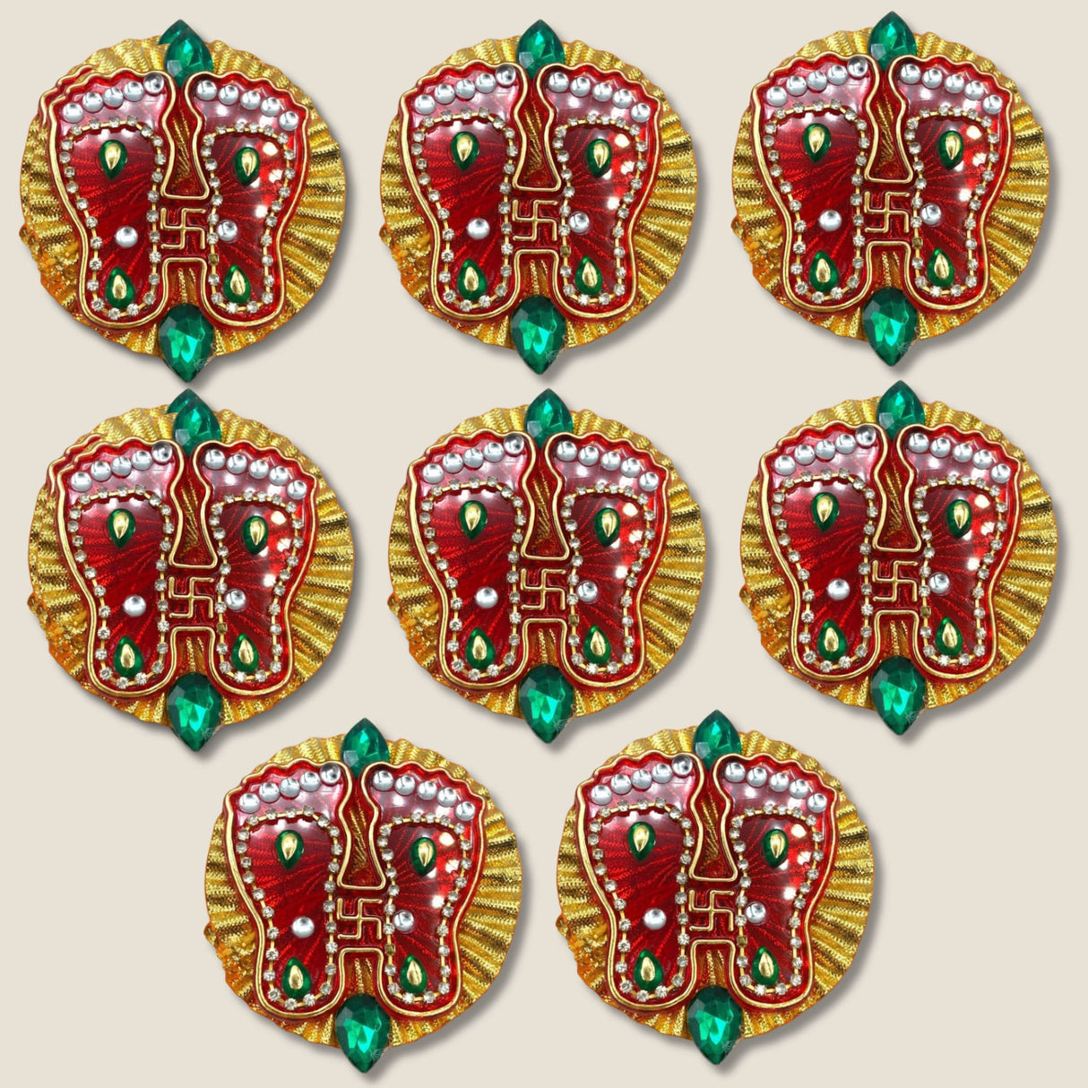 Acrylic Lakshmi Charan Paduka feet adorned with red and gold designs, green gemstones, and silver beads for Diwali decor