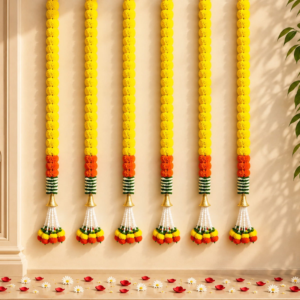 Artificial marigold garland with yellow and orange flowers green striped accents and golden cones for festive décor