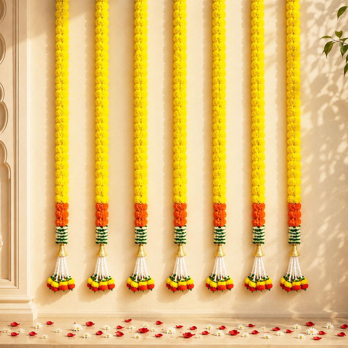 Six vibrant yellow artificial marigold garlands with orange and green bands and white flower tassels for festive decor