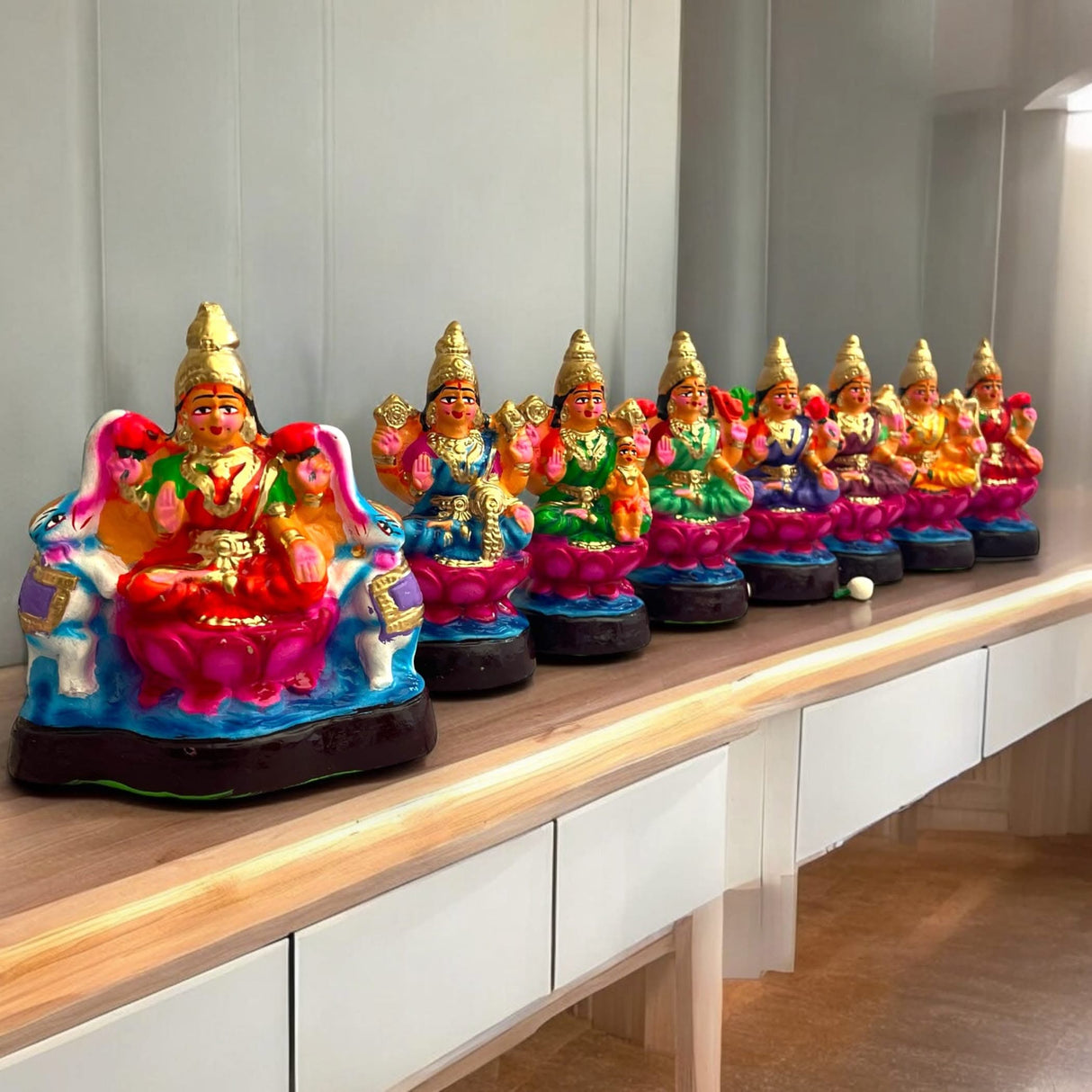 Colorful Lakshmi statues arranged in a traditional Golu doll set for Navratri and Diwali celebrations