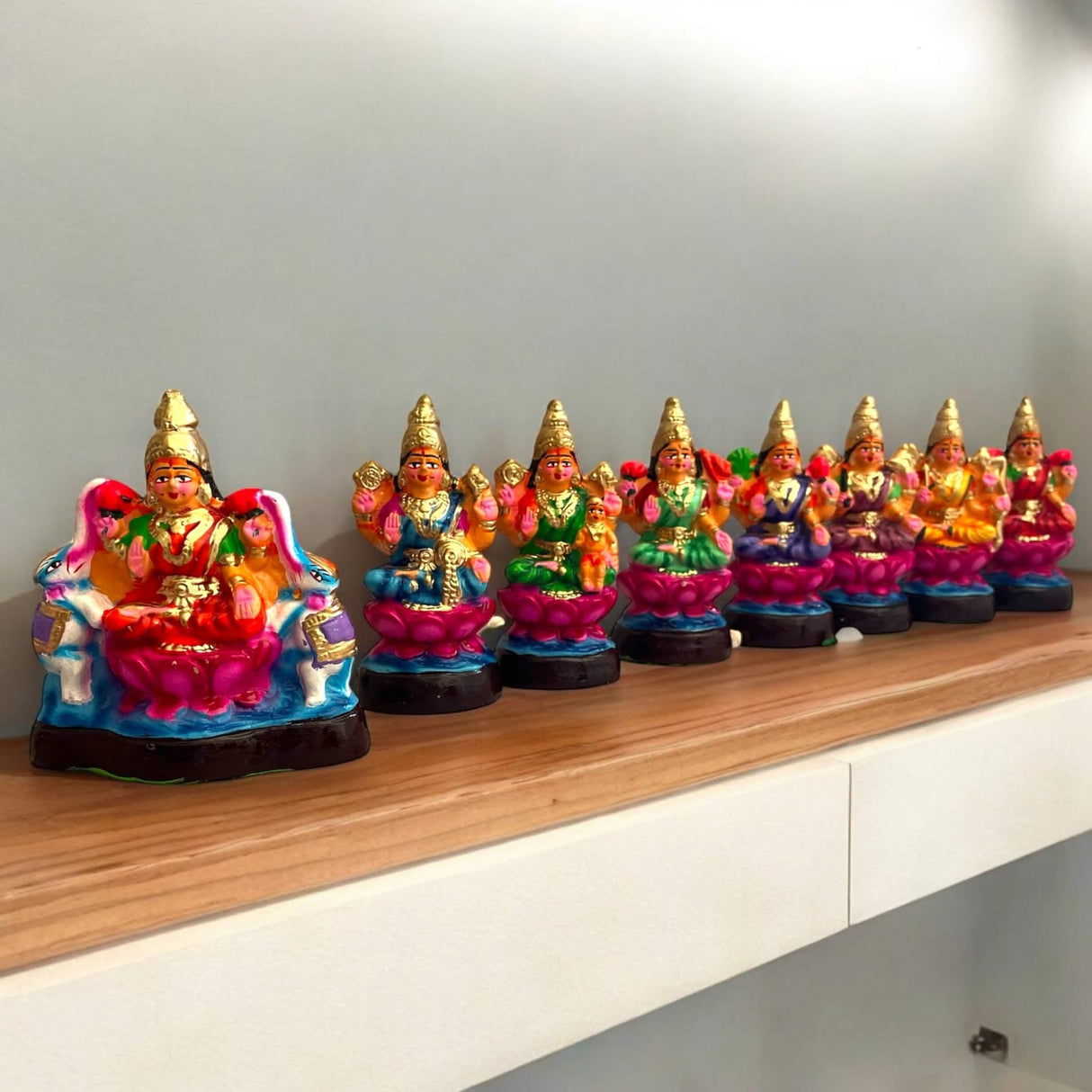 Colorful Lakshmi statues displayed in a traditional Golu Doll Set for Navratri and Diwali decor