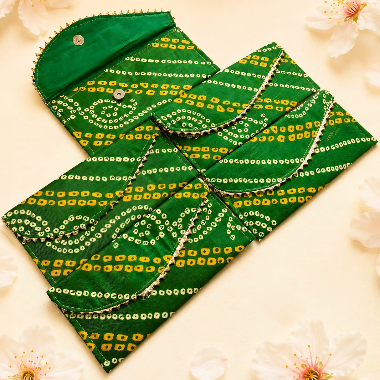 Green brocade fabric money envelope with yellow white geometric bandhani pattern and metallic trim for indian weddings