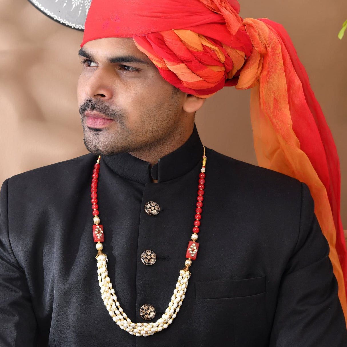 Red and orange silk turban with gold beads for wedding baraat milni mala