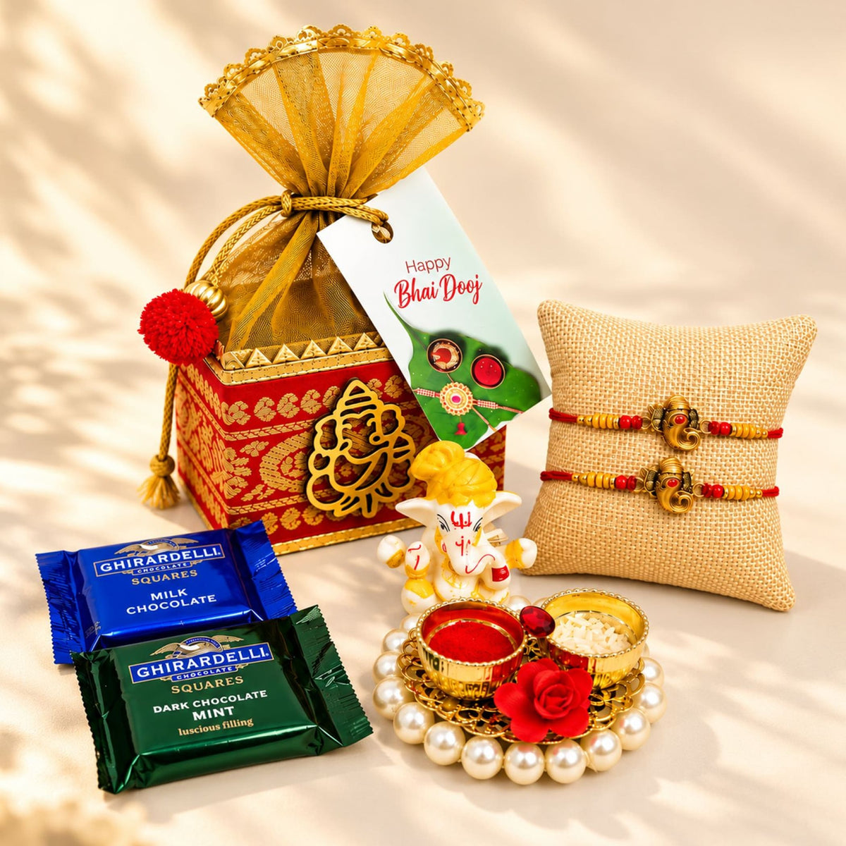 Gold-colored decorative gift box with intricate red and gold patterns and golden fan-shaped drawstring closure for bhai dooj hamper