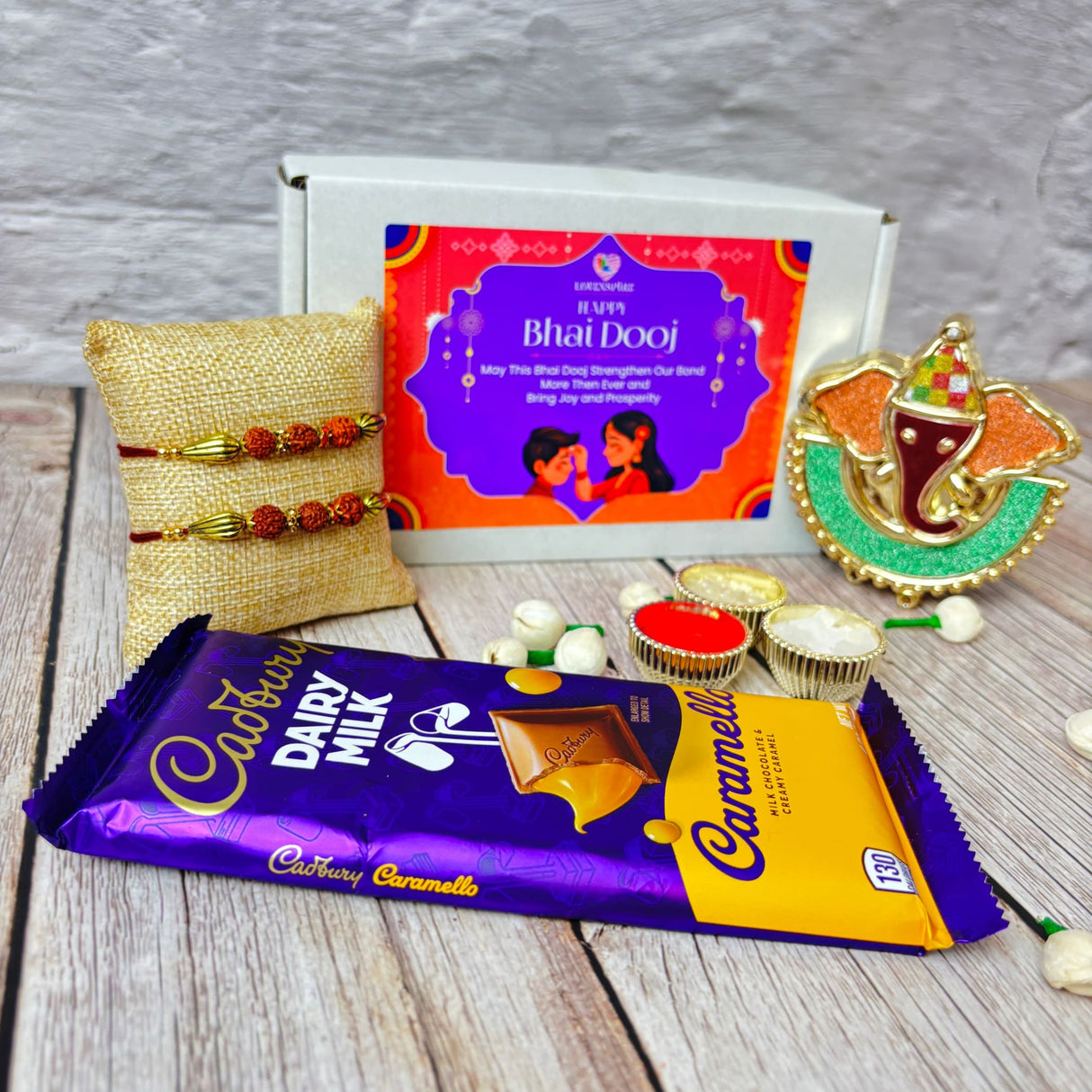 Bhai Dooj gift hamper with chocolates, Rakhis, Ganesha idol, and festive accessories