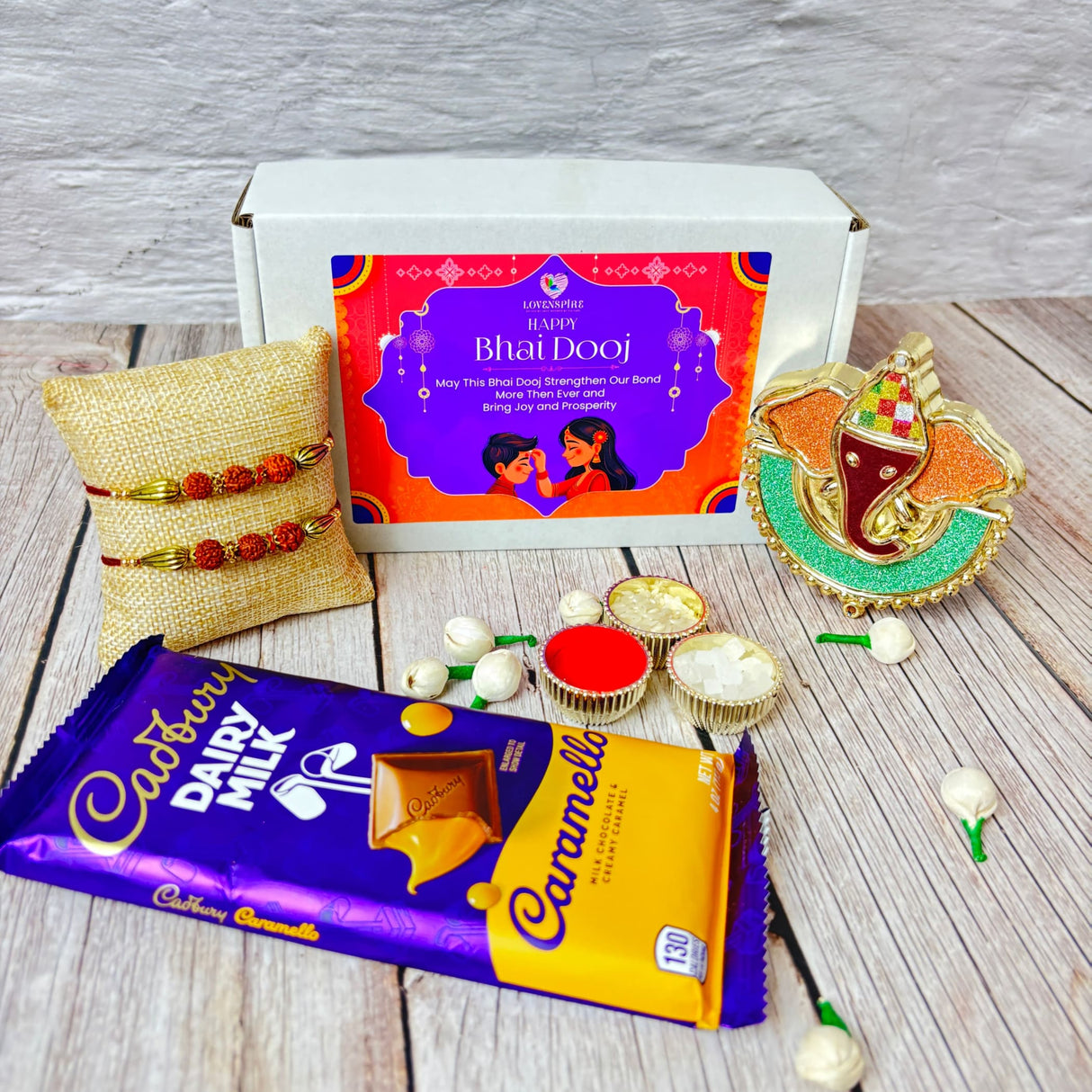 Bhai Dooj gift hamper with chocolates, bracelets, Ganesha idol, and accessories for brother