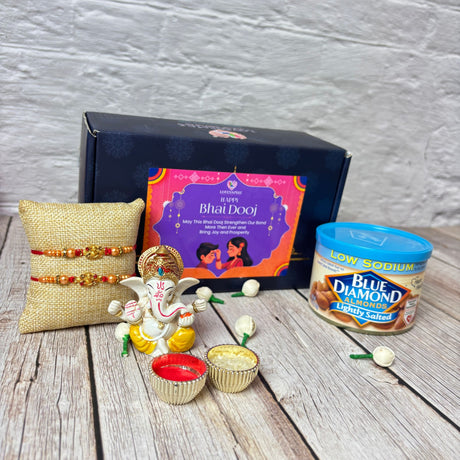 Bhai Dooj gift set with Ganesha idol, rakhis, bowls, and Blue Diamond almonds