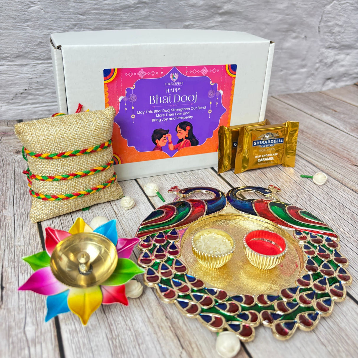 Bhai Dooj gift box with puja thali, chocolates, diya, and rakhi for brother celebration