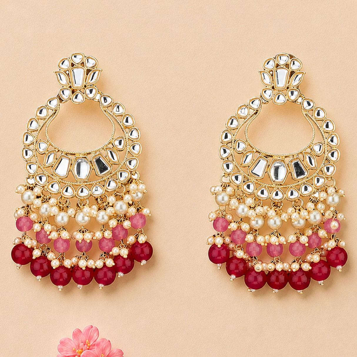 Oversized indian kundan gold tone chandelier earrings with intricate mirror work and pink red bead strands for ethnic wear