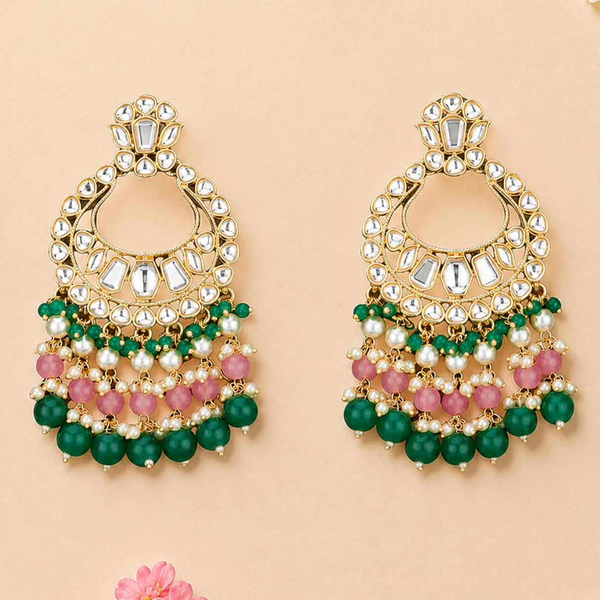Elegant gold tone oversized Indian kundan chandbali earrings with mirror stones, layered green pink beads, and pearl accents