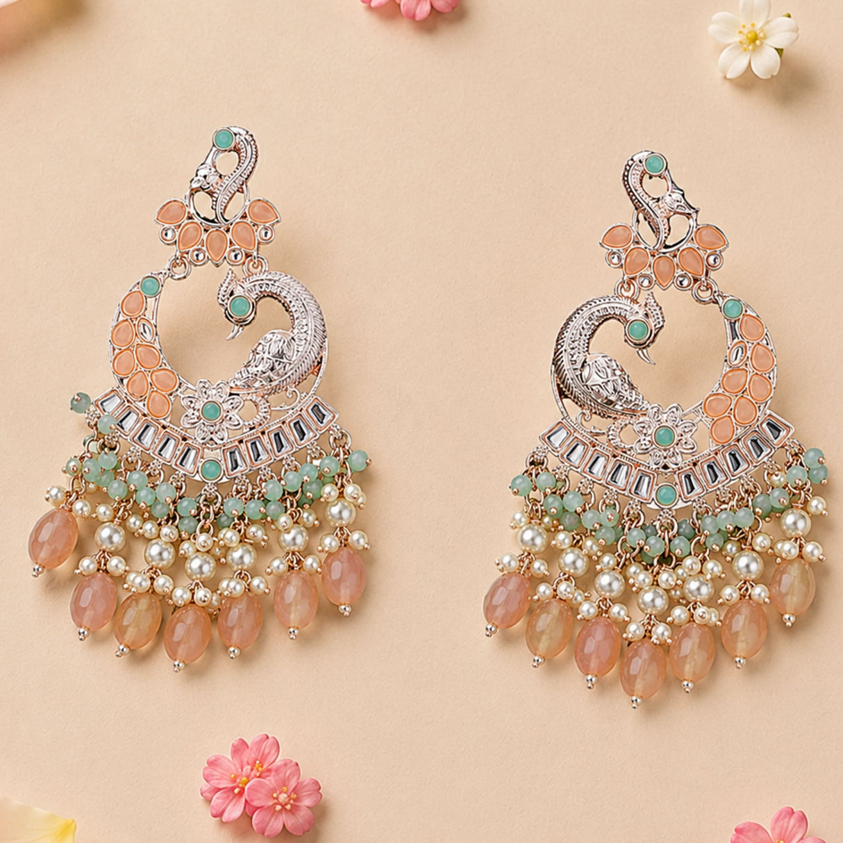 Silver oversized peacock-shaped kundan jhumka earrings with peach and mint stones pearls for wedding and ethnic wear