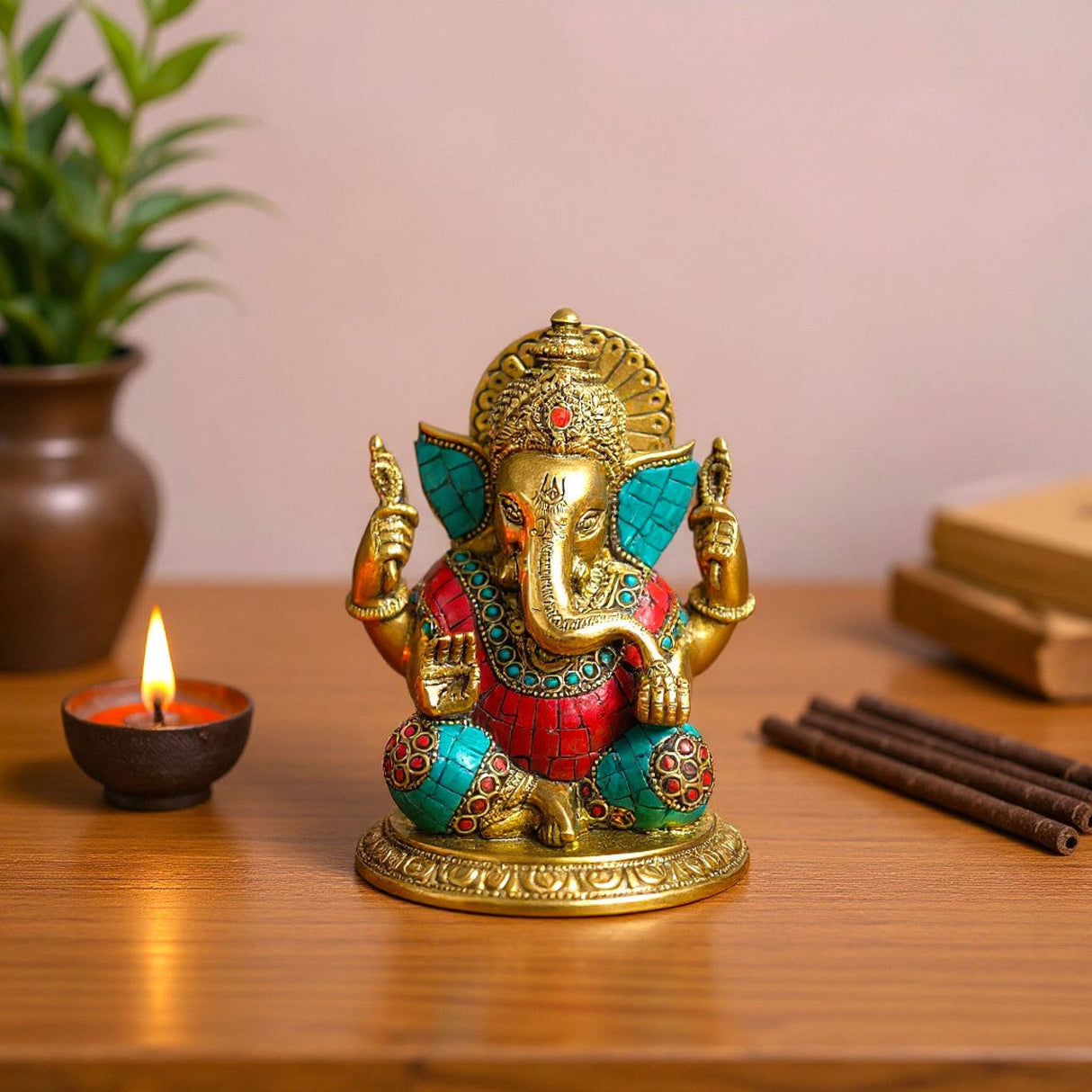 Golden Ganesha brass statue with turquoise red inlay, intricate elephant head arms