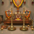 Brass oil lamp set with intricate designs and multiple wicks for Diwali decoration