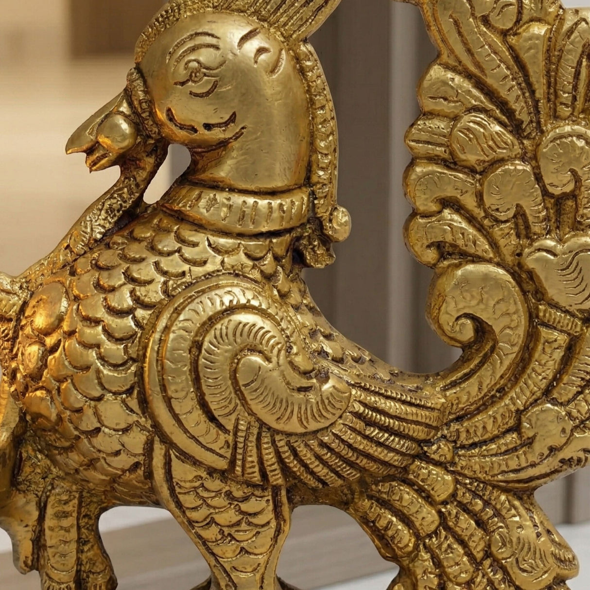 Golden brass figurine of a mythical bird with intricate feathered wings and detailed scales for diya lamp decoration