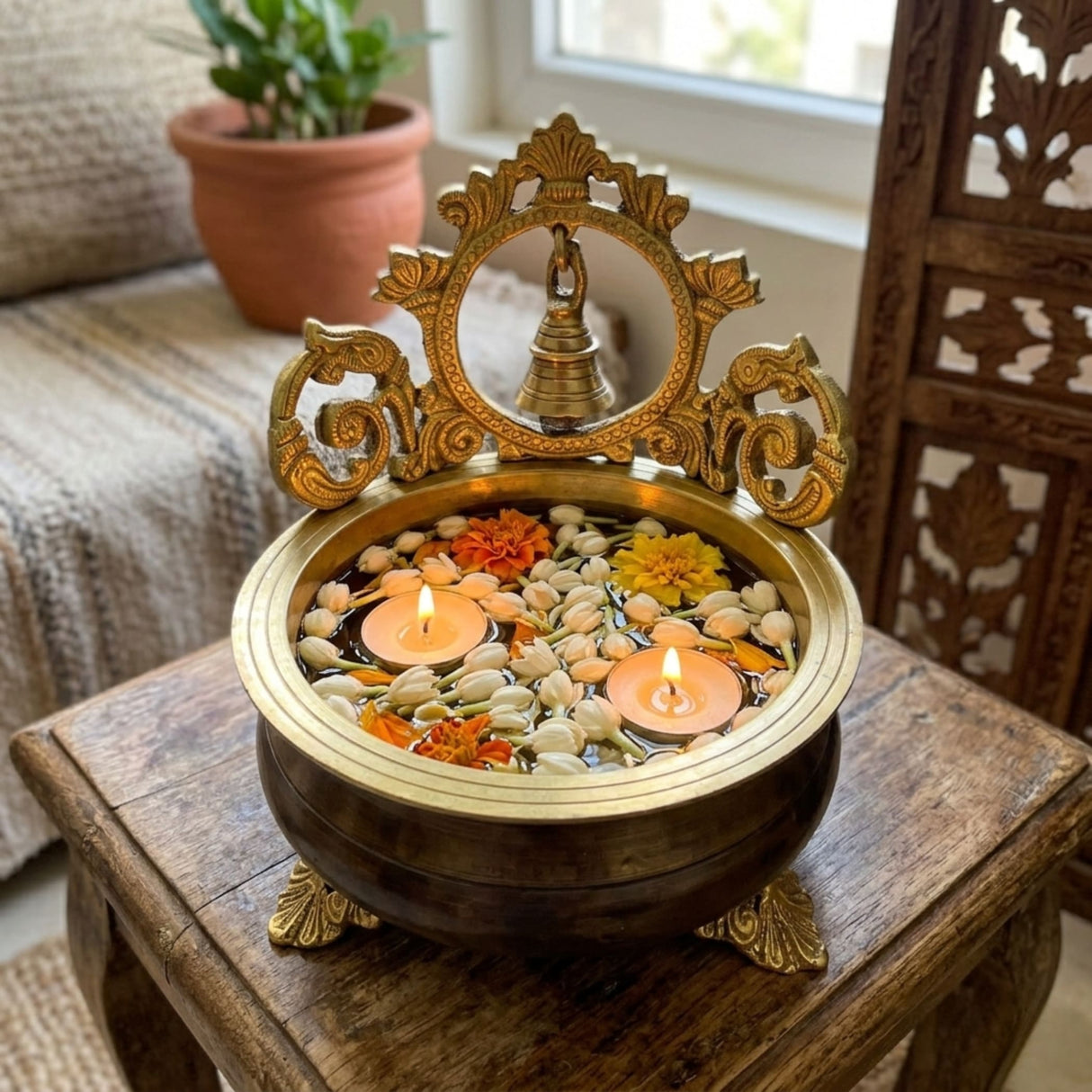 7 inch brass urli bowl with bell, ornate floral design, jasmine flowers, candles