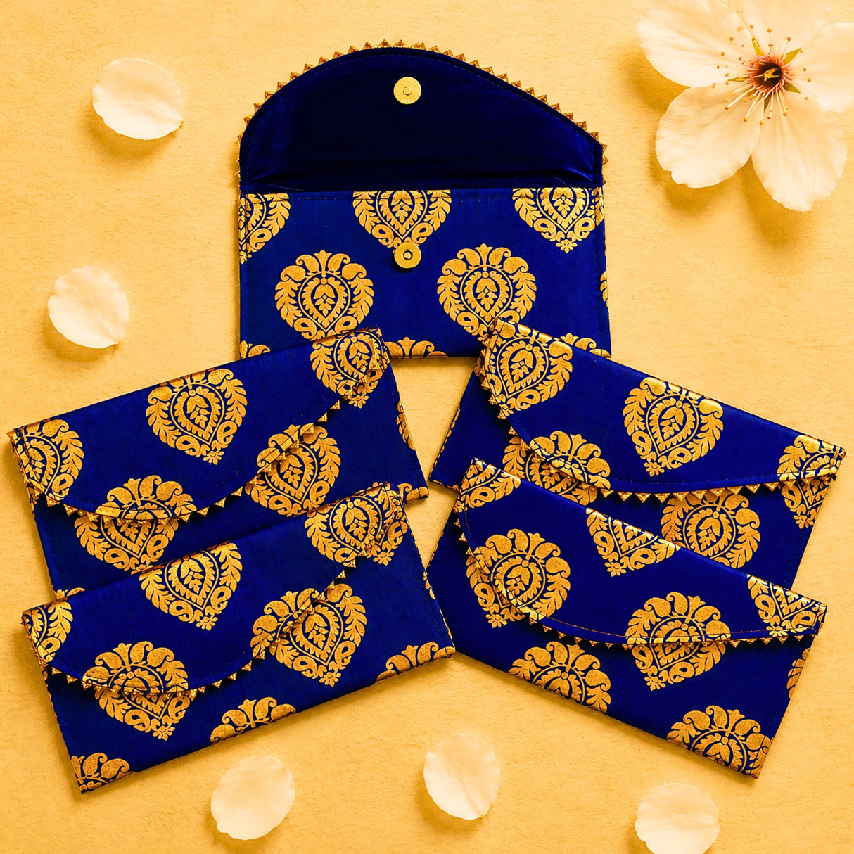 Brocade fabric money envelope in deep blue velvet with intricate gold paisley embroidery and button closure for gifting