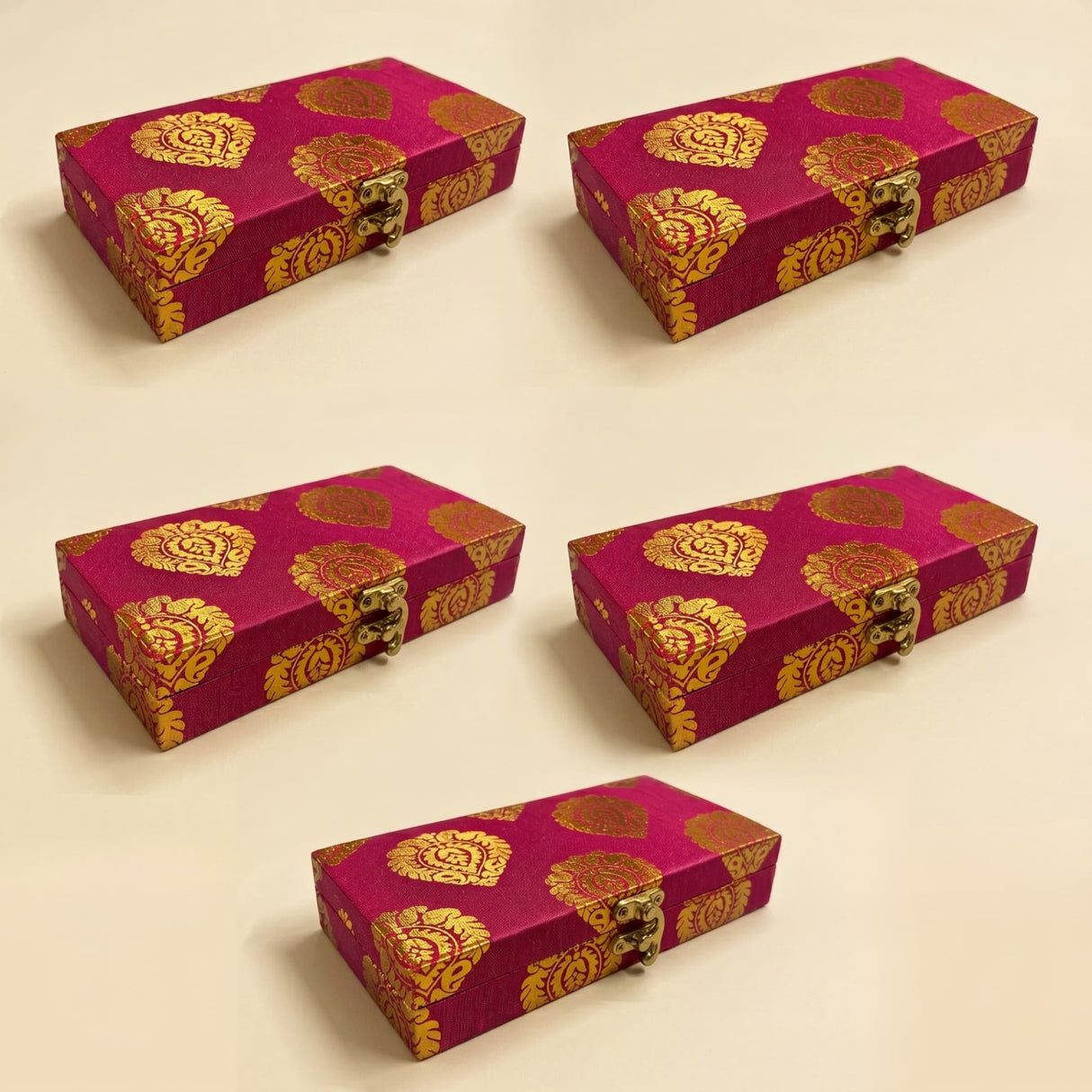 Fuchsia brocade gift boxes with gold and red ornate patterns and brass clasps for Indian Muslim wedding favors