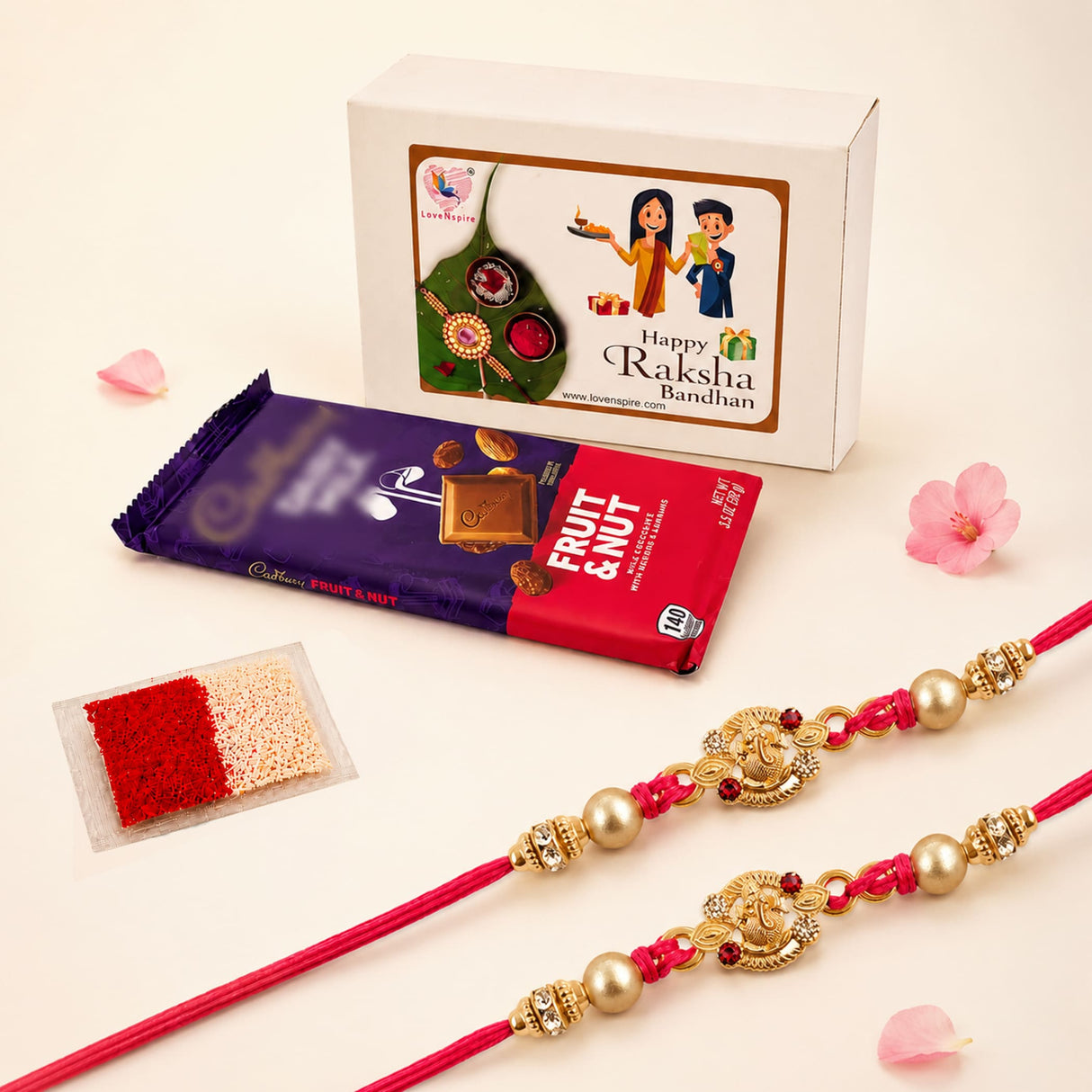 Two vibrant red handmade rakhi bracelets with gold-colored metalwork and pearl beads in Ganesha rakhi gift hamper set
