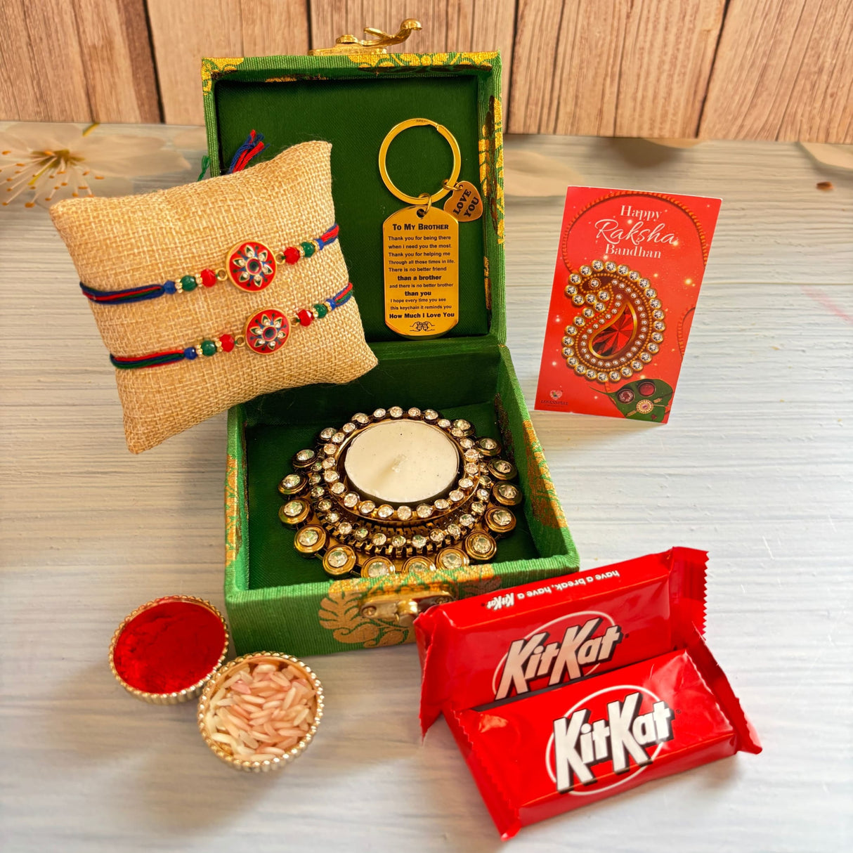 Green ornate gift box containing a decorative golden crystal candle holder from designer rakhi gift hamper for brother and bhabhi