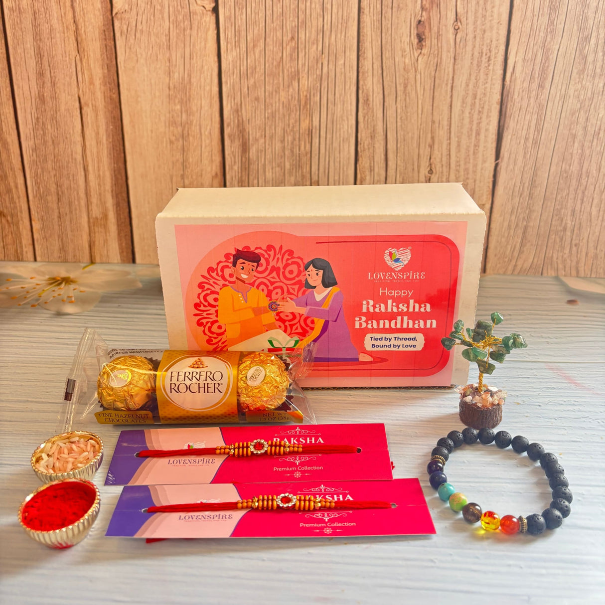 Red and gold designer rakhi with intricate beadwork from gift hamper for brother and bhabhi symbolizing love and good luck