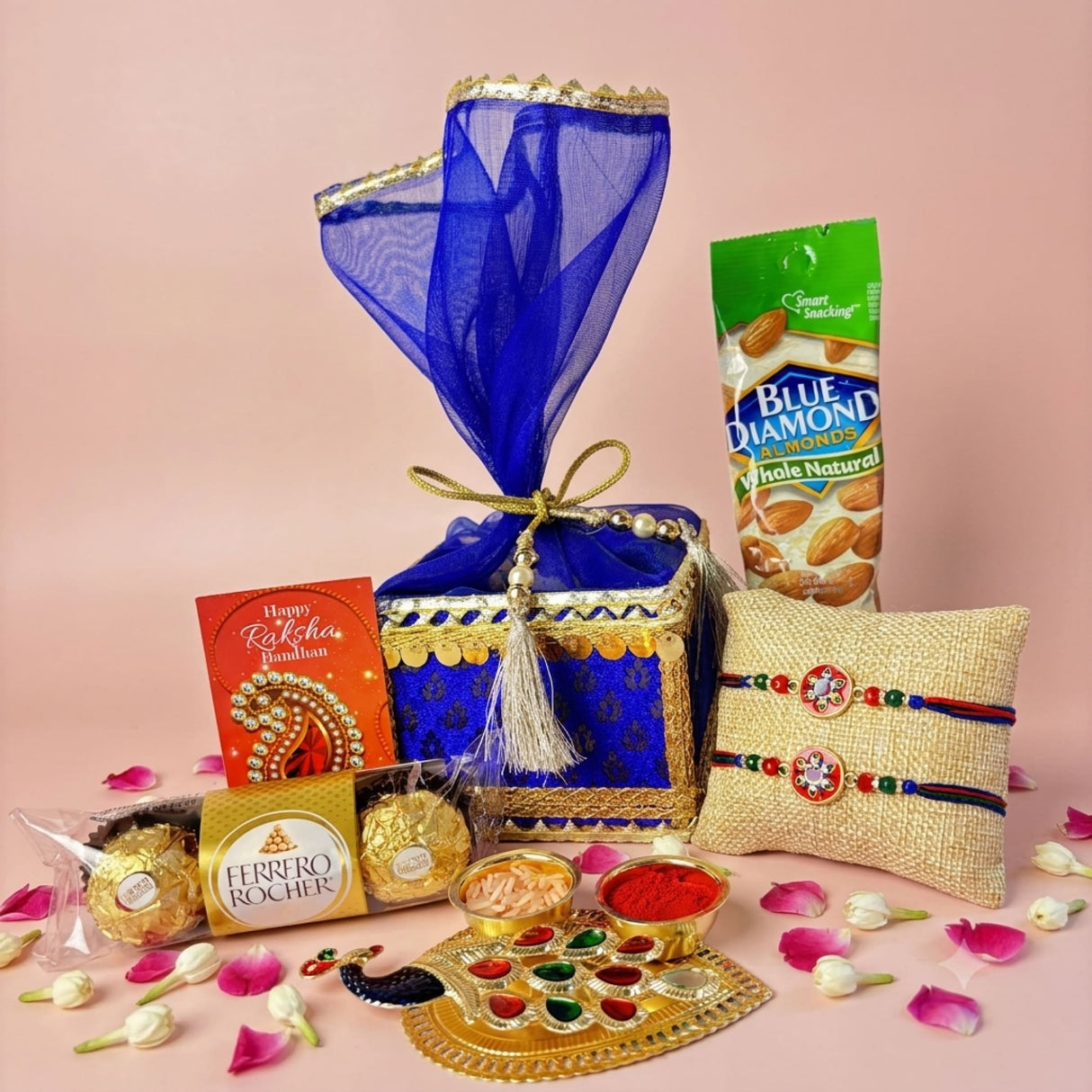 Blue and gold ornate designer rakhi gift hamper box wrapped in sheer blue organza with golden ribbon for brother and bhabhi