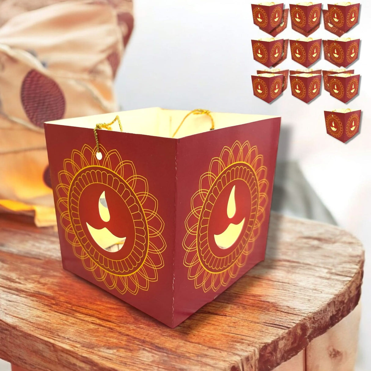 Red paper lantern with cutout Diya designs and gold accents for Diwali decoration