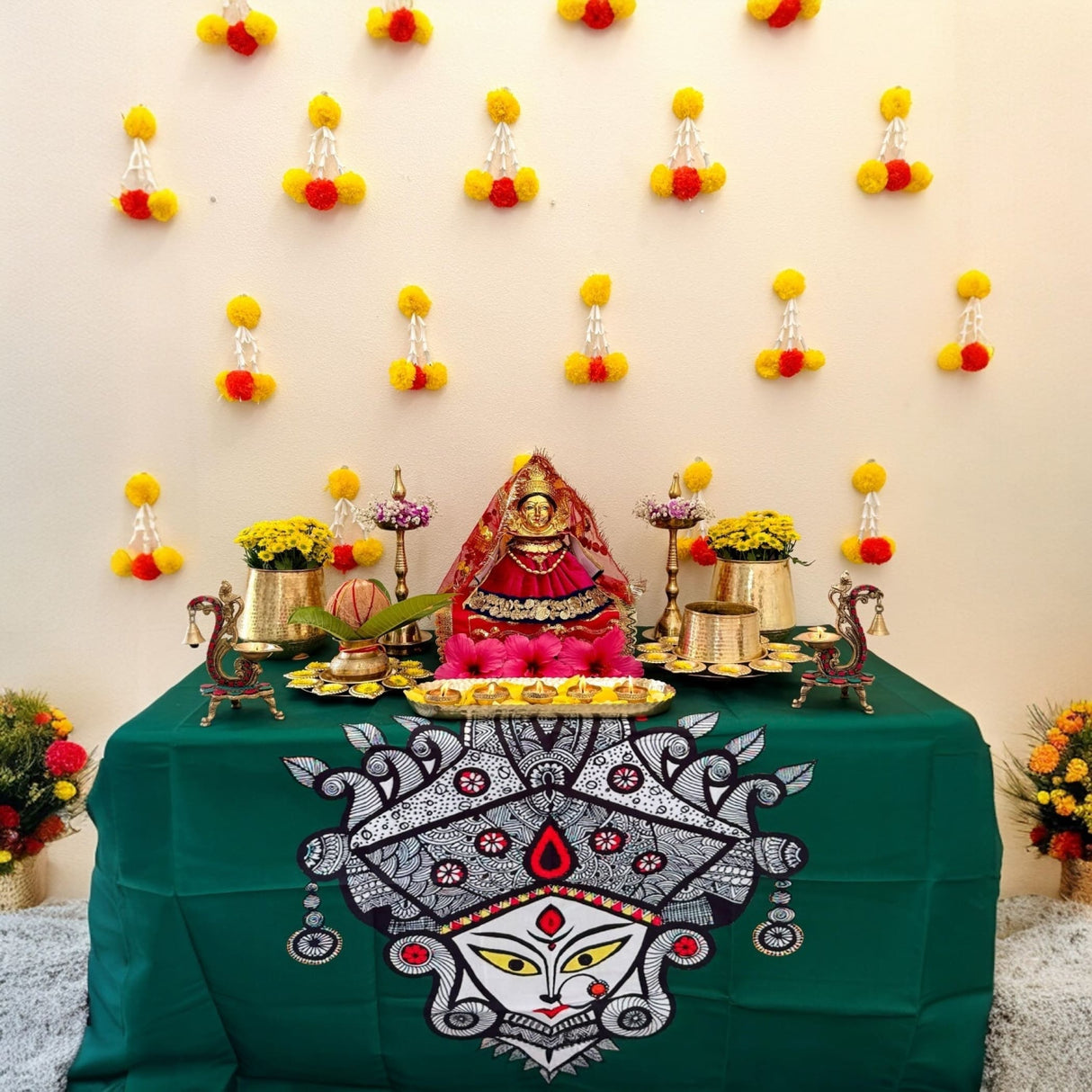 Beautifully decorated goddess idol on green tablecloth for Diwali and wedding celebrations