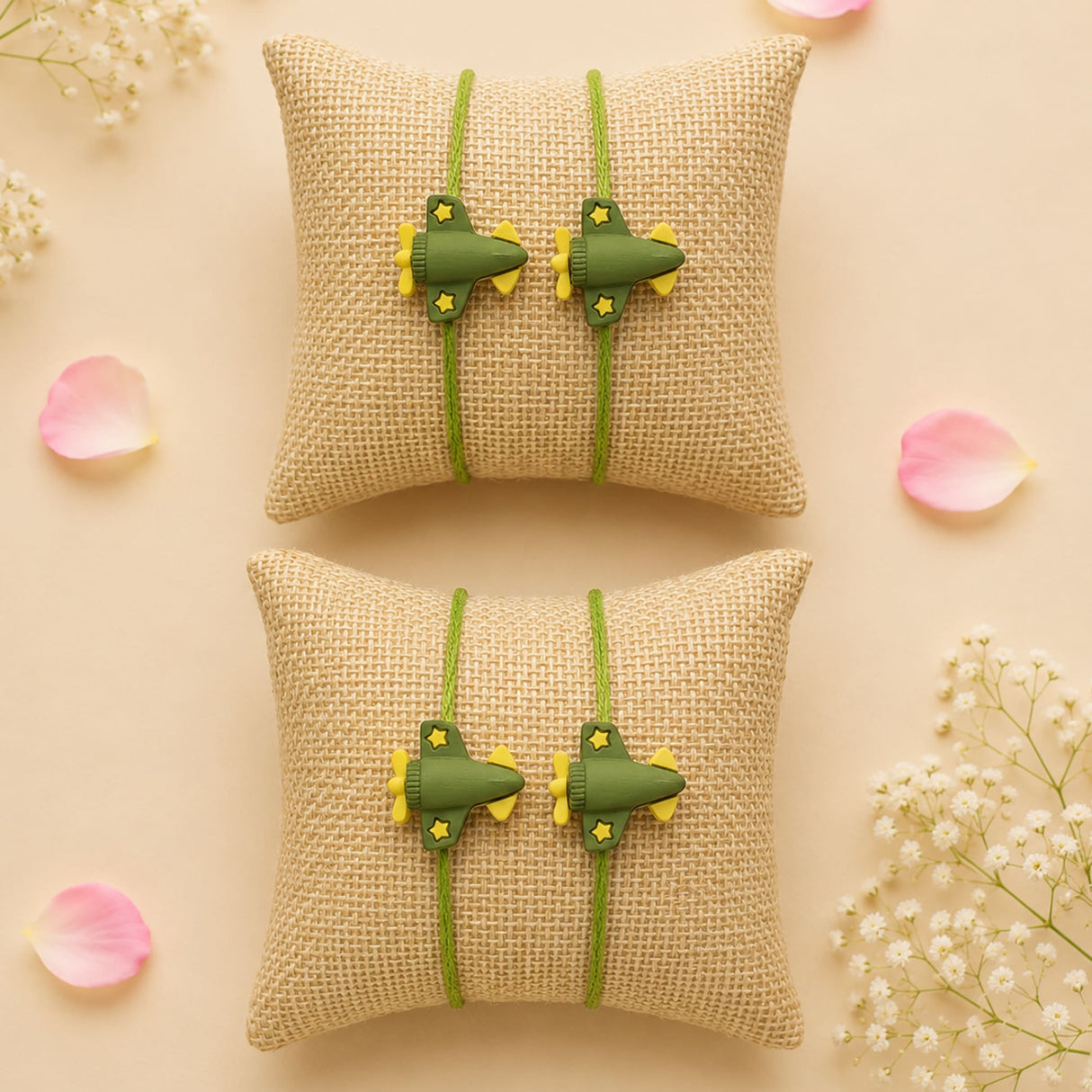 Cartoon rakhi for brother featuring green plastic airplane-shaped ring holders with yellow accents on green cords