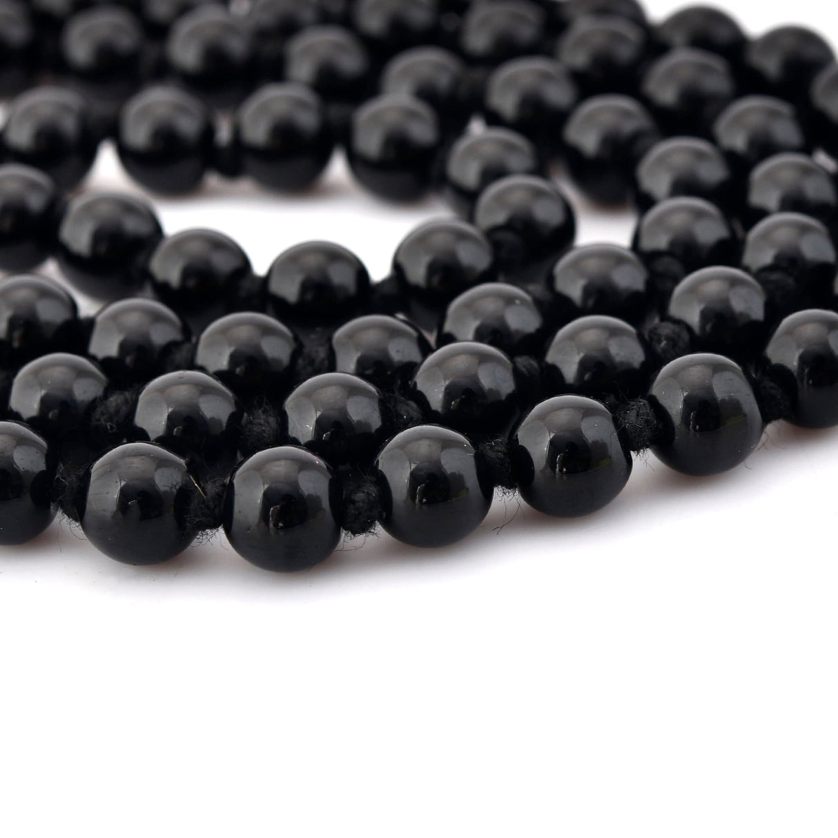 Black beaded mala necklace with tassel from LOVENSPIRE, natural healing gemstone jewelry