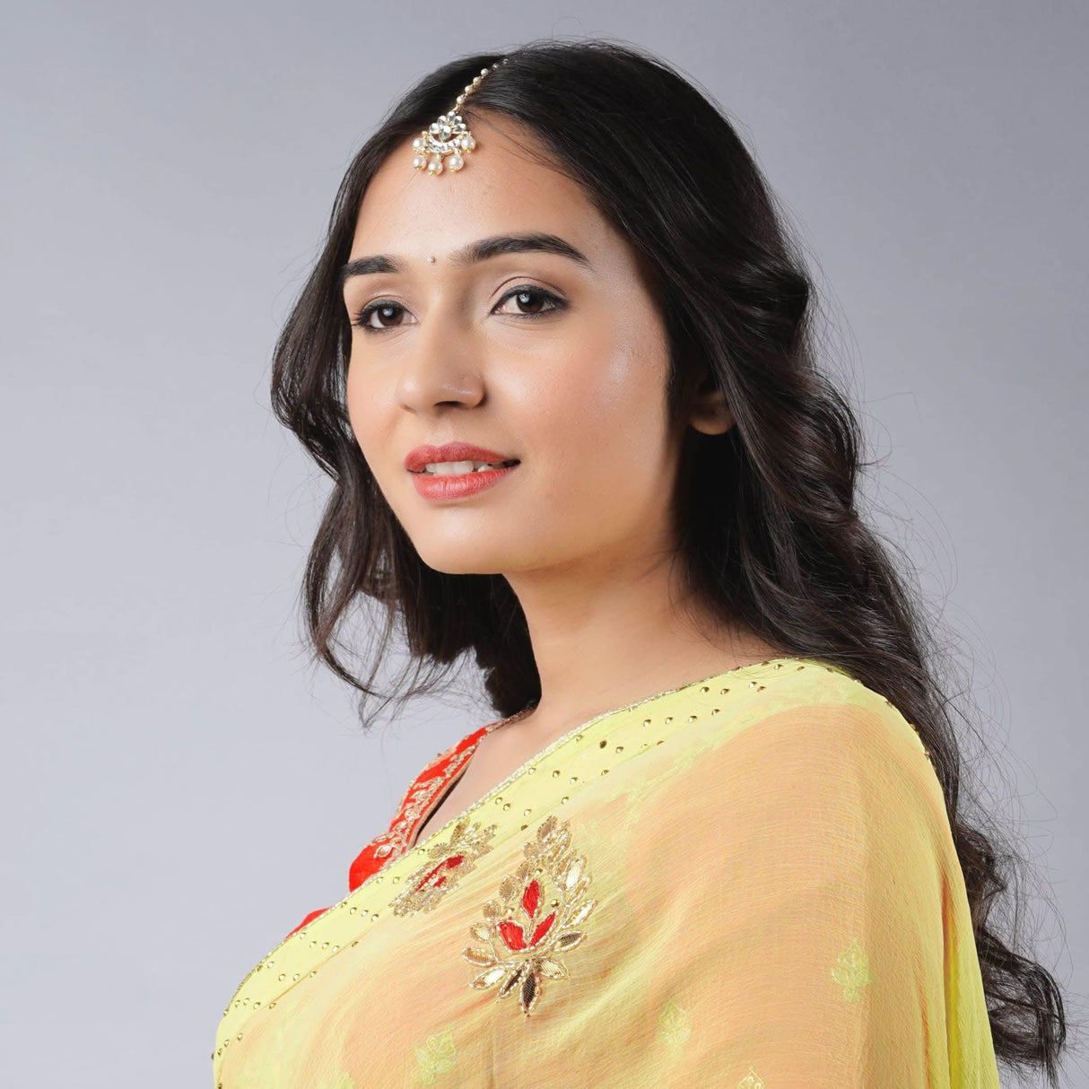 Gold-plated Chand Tikka maang tikka with floral design and stones
