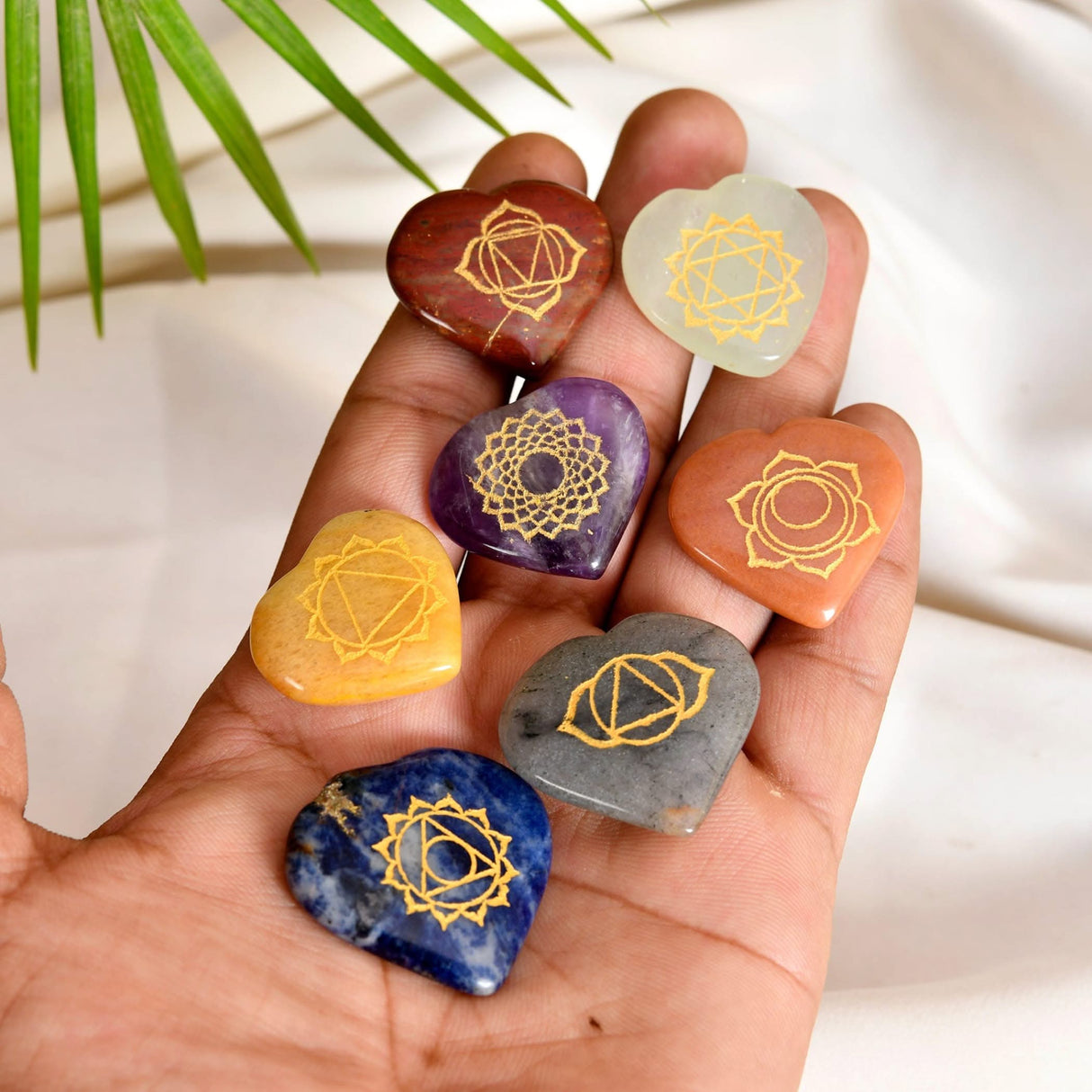 Seven heart-shaped chakra stones for meditation and energy balancing therapy