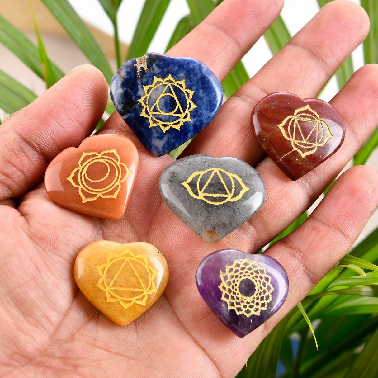 Seven chakra heart-shaped stones for meditation and energy balancing in a healing kit