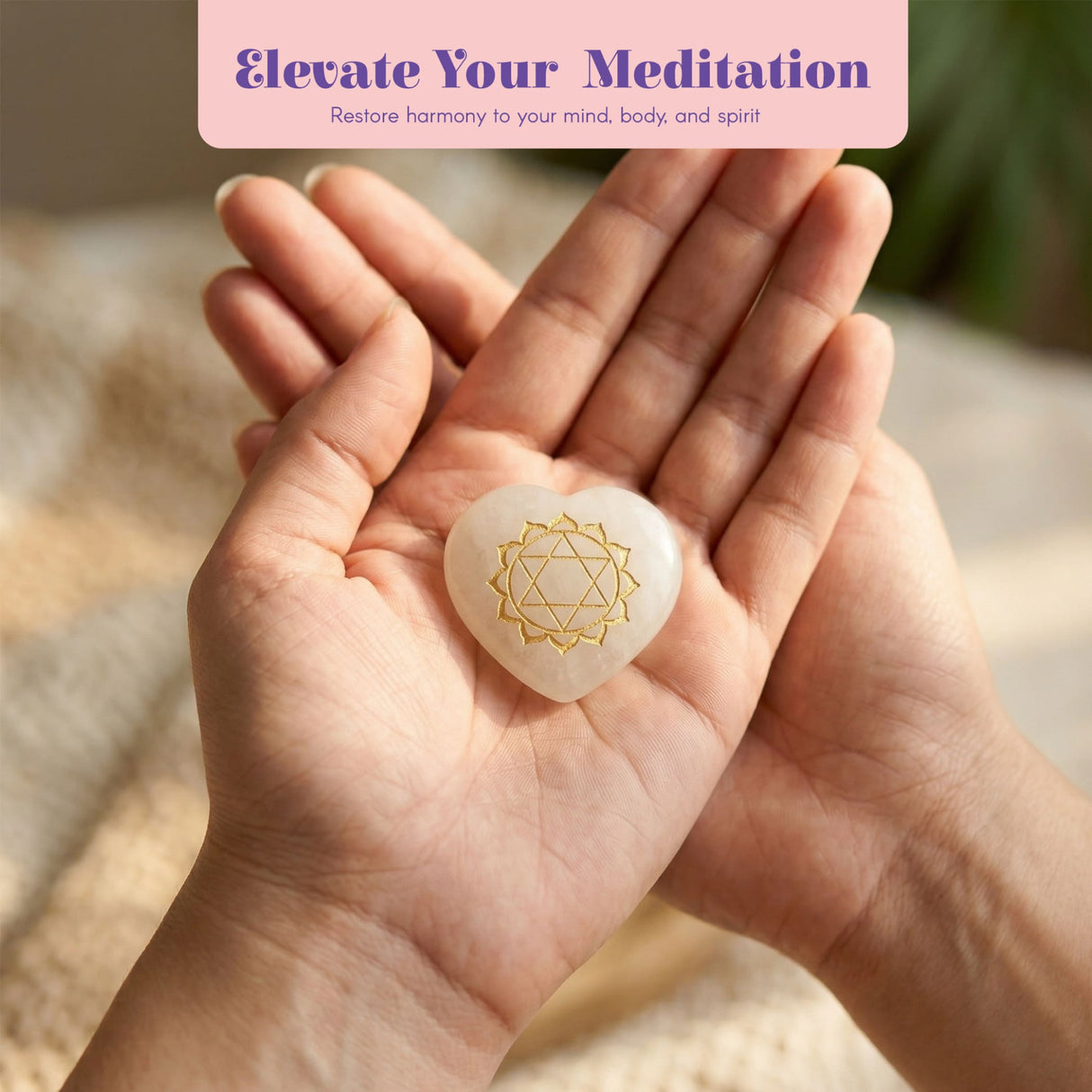 A heart-shaped white stone meditation chakra pendant with gold geometric design from a healing crystals kit